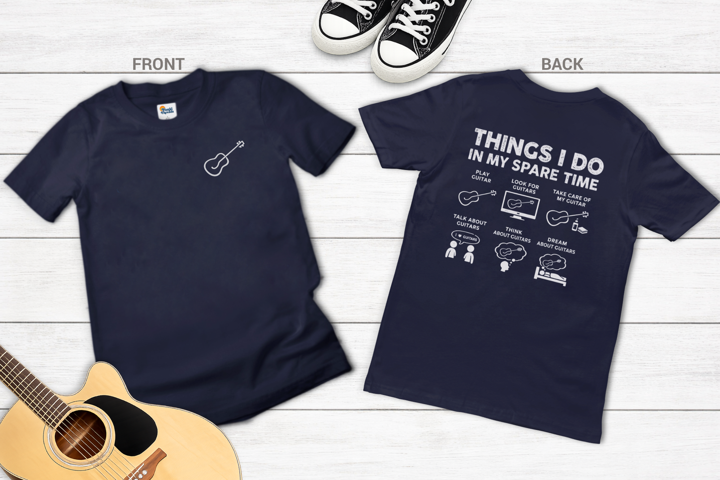 Navy blue t-shirt with guitar graphic on front and text on back, displayed on a wooden surface.