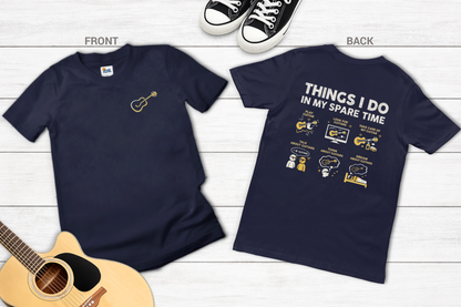 Navy blue t-shirt with front and back designs on a wooden surface with a guitar.