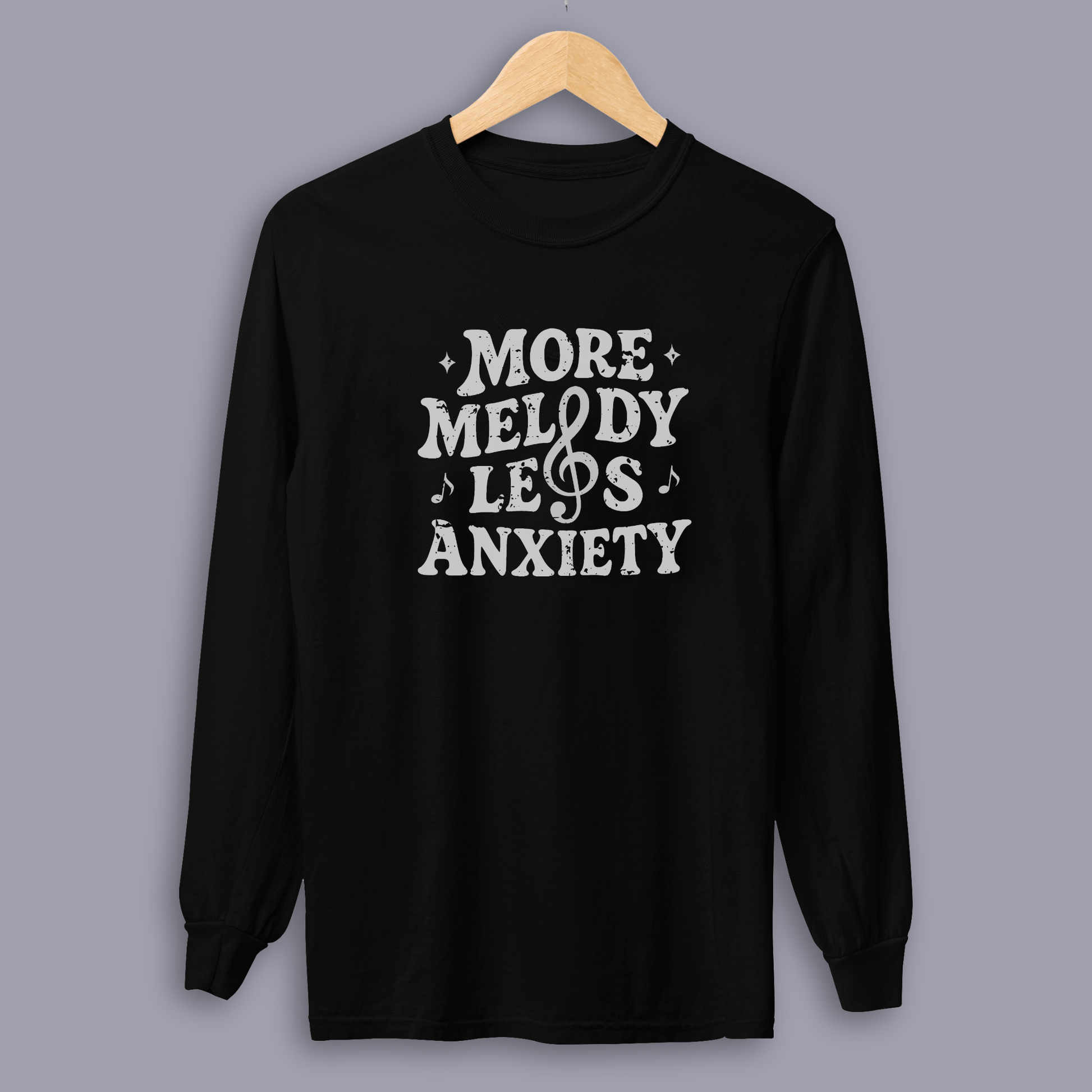 Person wearing the More Melody Less Anxiety mental health music long sleeve shirt