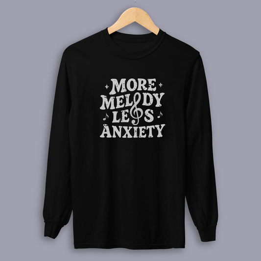 Person wearing the More Melody Less Anxiety mental health music long sleeve shirt