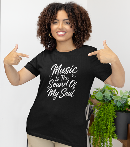 Woman wearing a black t-shirt with 'Missional Obedience' text and globe graphic, pointing at the shirt.