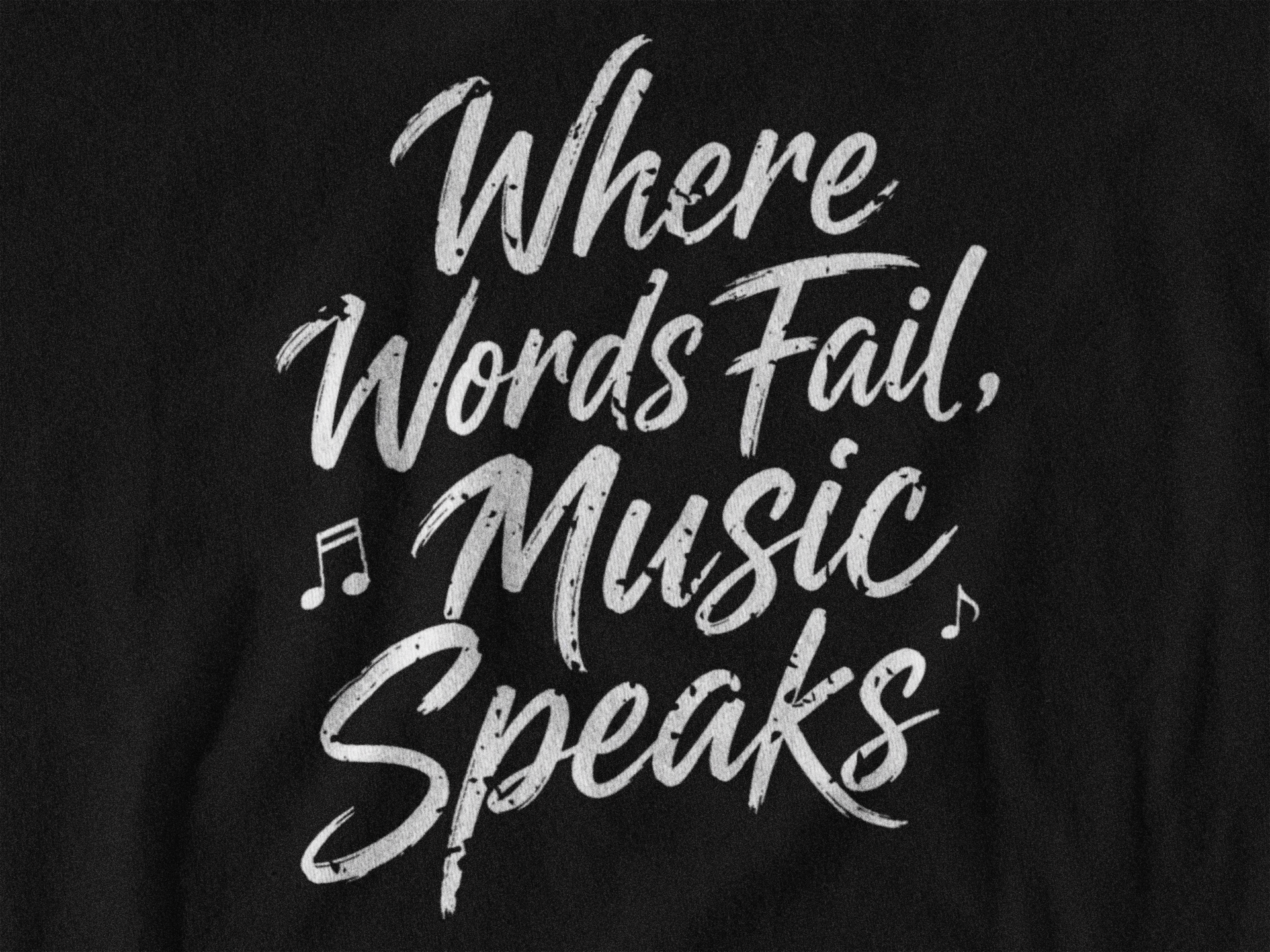 Close-up detail of the 'Where Words Fail, Music Speaks' script print on the women's fitted tee.