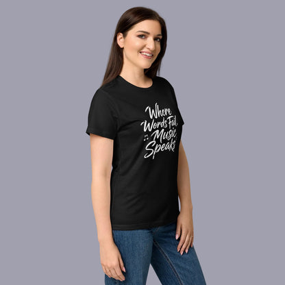 A woman modeling a black short-sleeve graphic t-shirt with the white printed text 'Where Words Fail Music Speaks' on the chest, paired with blue jeans against a plain white background.